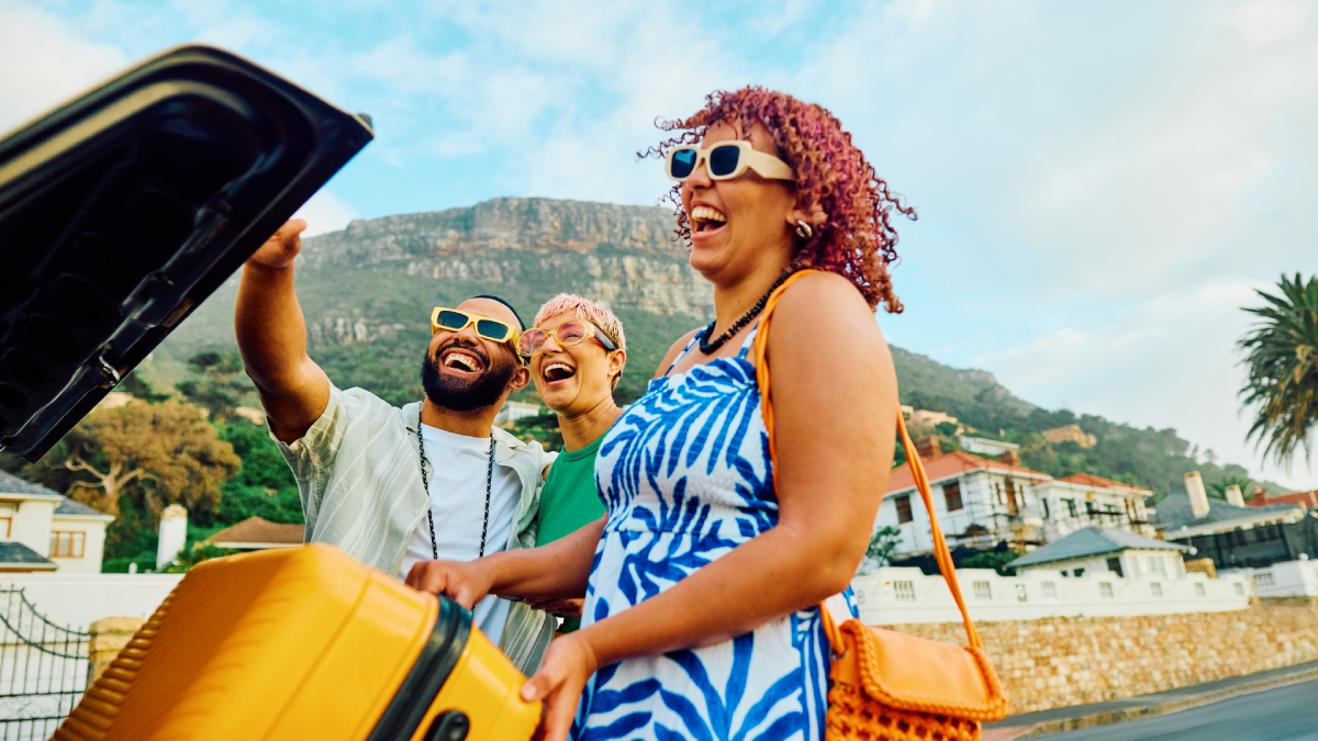 Woman laughing outside a yellow car