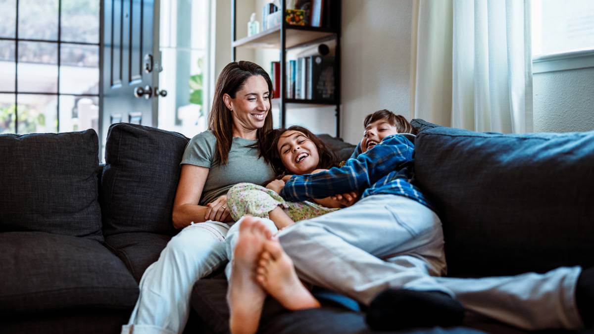 Family laughing on the couch